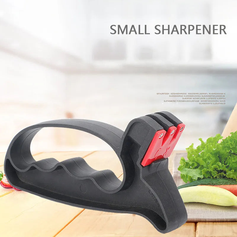 Black handheld knife and scissor sharpener with ergonomic grip on white background