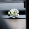 Jasmine-scented gypsum car air freshener ornament in off white or green, shown next to a 5ml essential oil bottle.