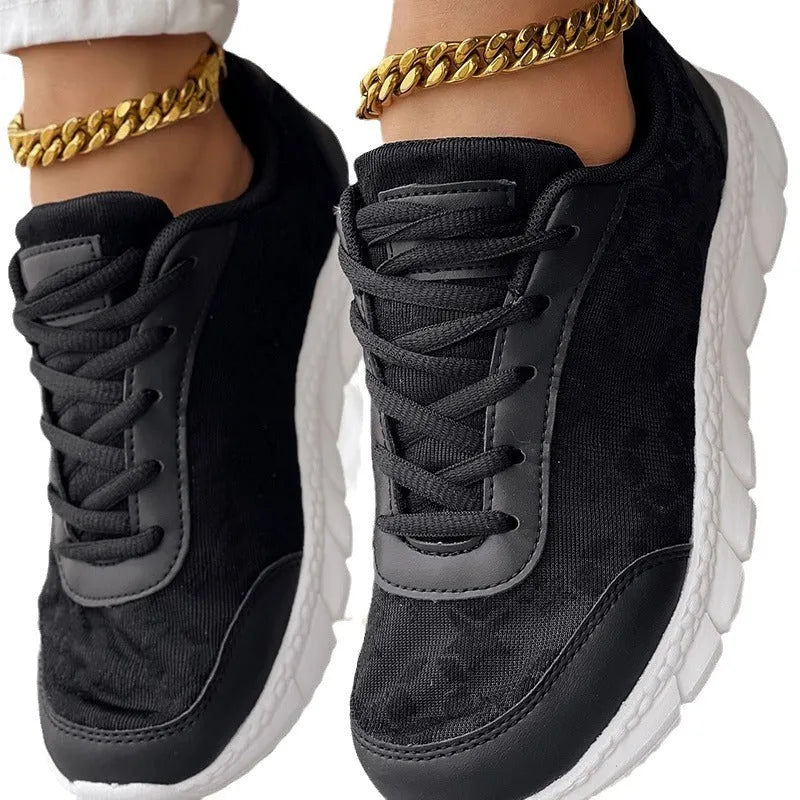 Women's white canvas running shoes with round toe and flat heel on solid background