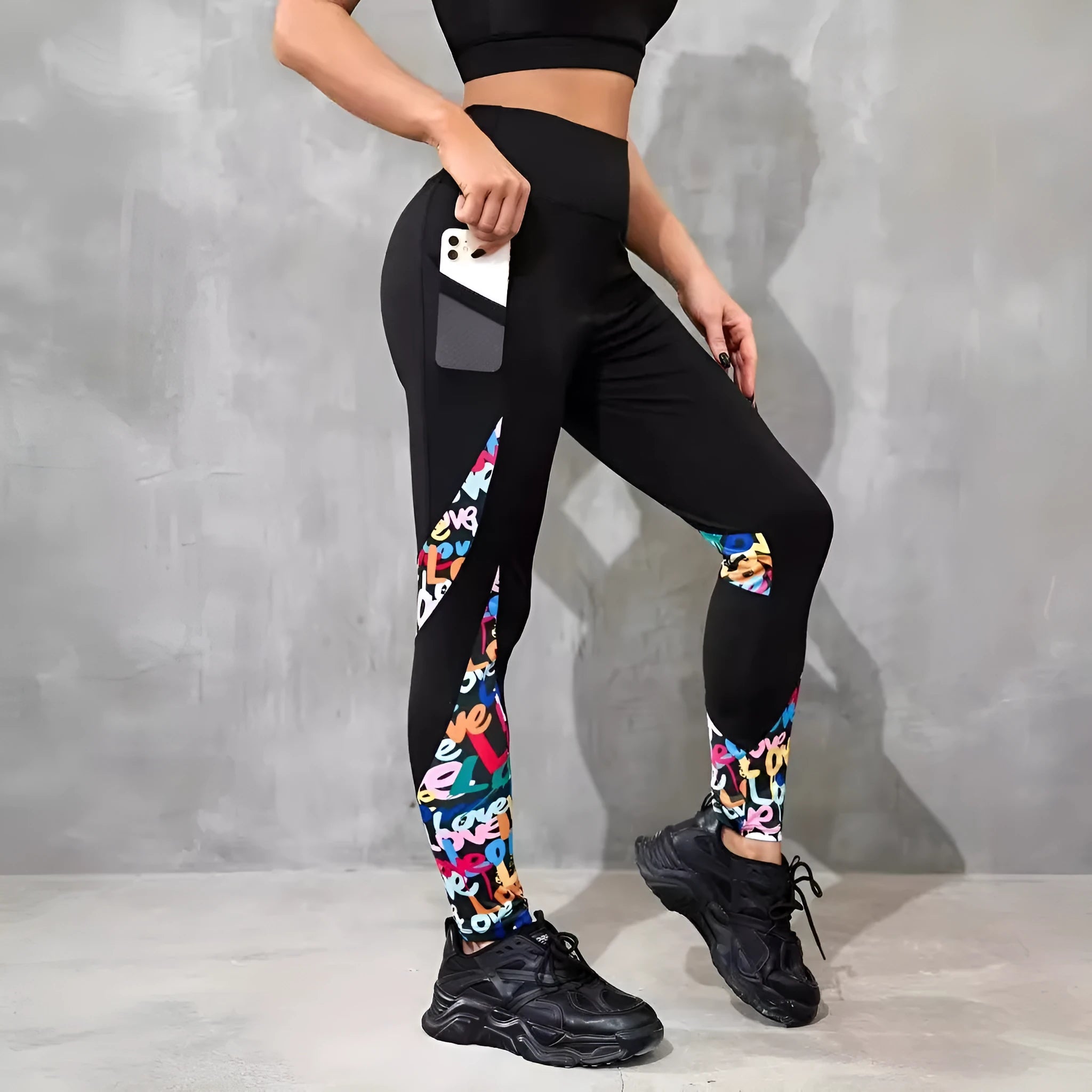 Women's black high-waisted cropped sports leggings with pocket detail and leopard print design