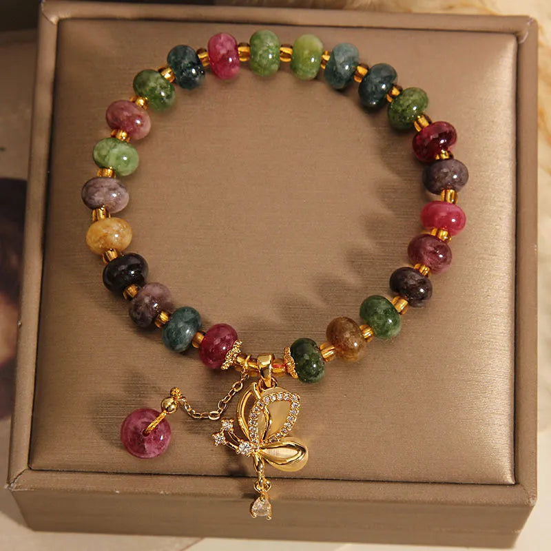 Colourful women's bracelet with a silver butterfly charm and multicoloured beads including tourmaline