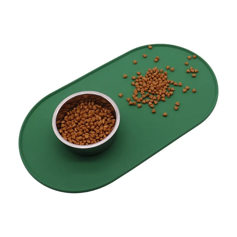 Green silicone waterproof cat feeding placemat with food bowl on it, showing non-slip textured surface.