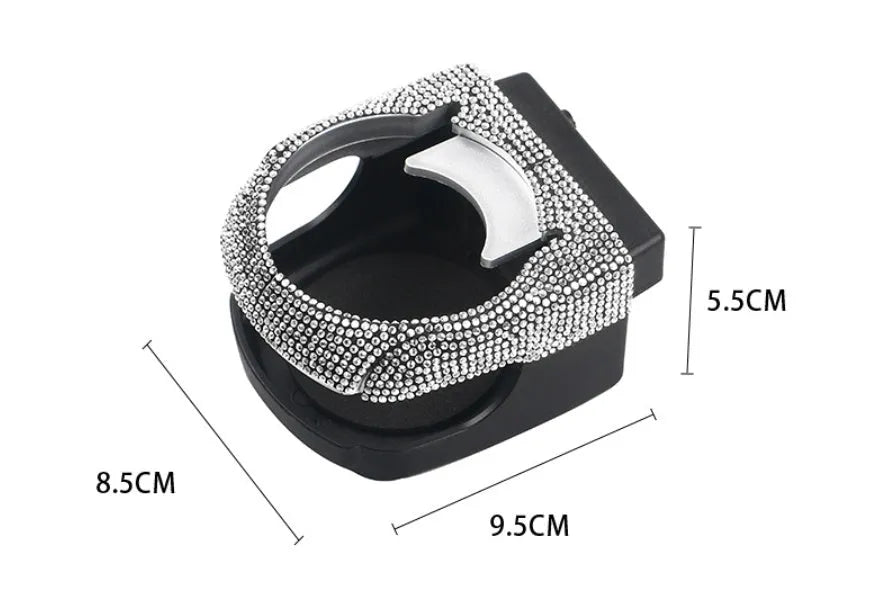 Car interior ashtray bracket with cup holder and rhinestone decoration mounted on air vent.