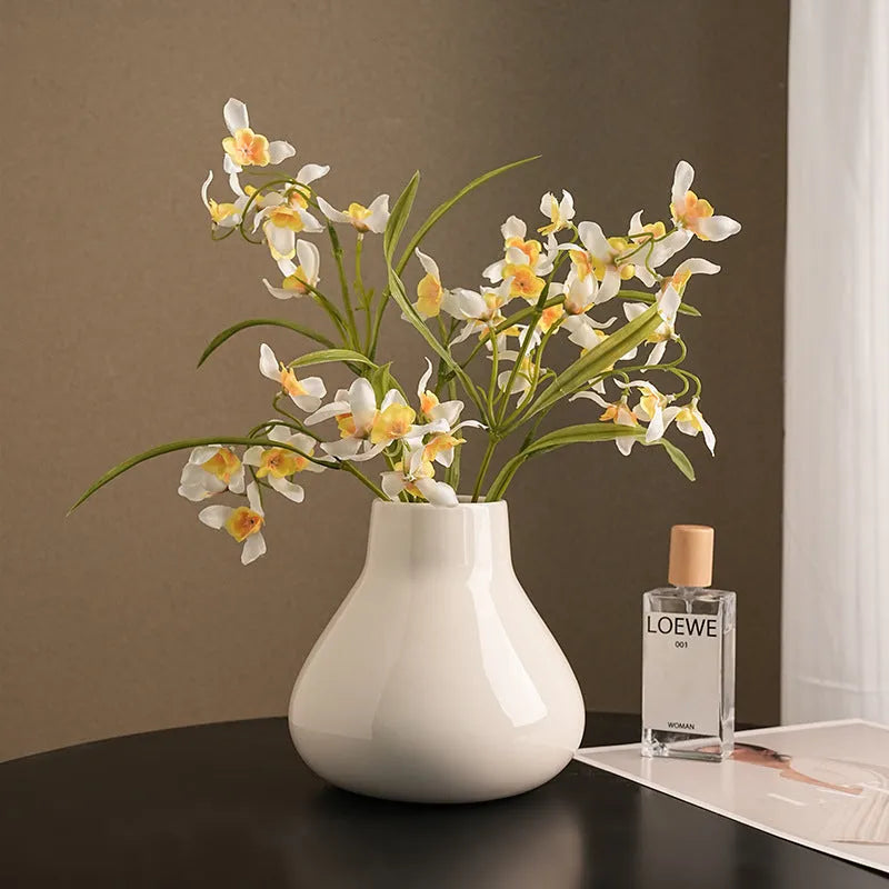 Ceramic round belly vase with coloured glaze finish and two orchid flowers in modern simplicity design