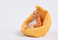 Lazy cat figurine on a sofa, a small resin car dashboard ornament.