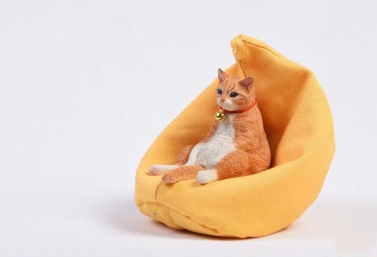 Lazy cat figurine on a sofa, a small resin car dashboard ornament.