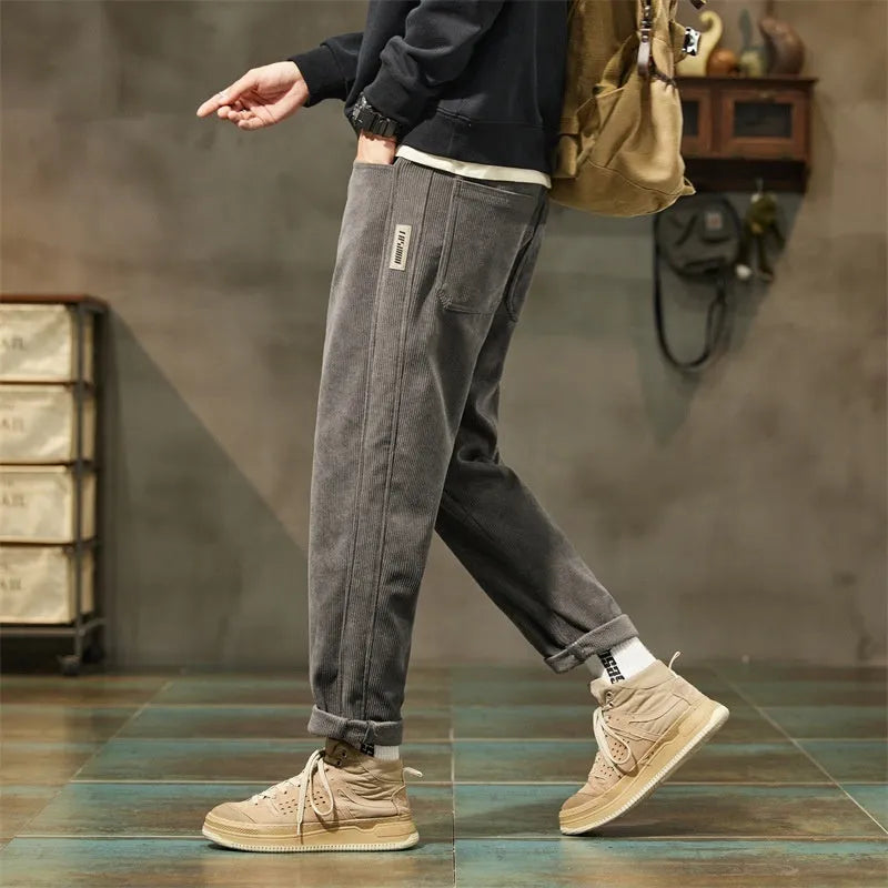 Men's corduroy casual trousers in tapered straight-leg style with mid waist and zipper fly closure