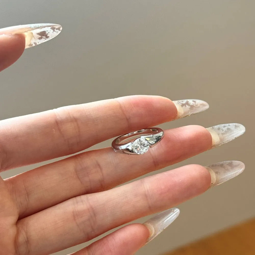 Silver round ring with glossy electroplated finish on display