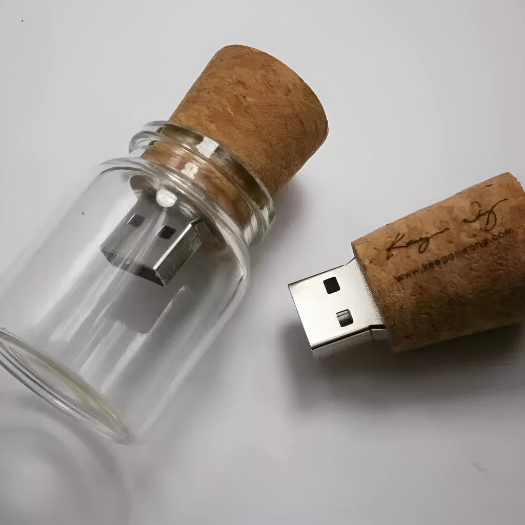 Transparent bottle-shaped USB flash drive on a wooden surface.