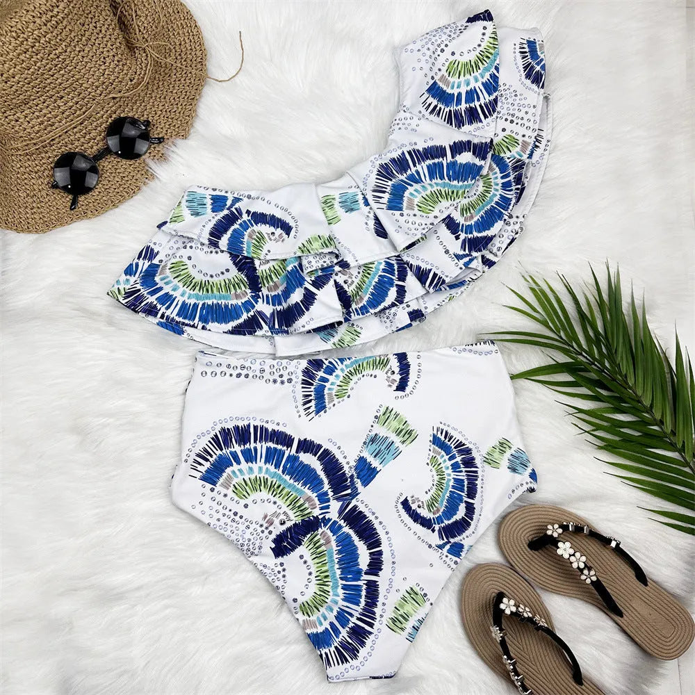 White one-shoulder women's swimsuit with large lotus leaf detail and high-leg split.
