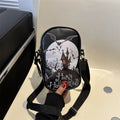 Black mini crossbody bag with Halloween graffiti print of cartoon pumpkins and bats.