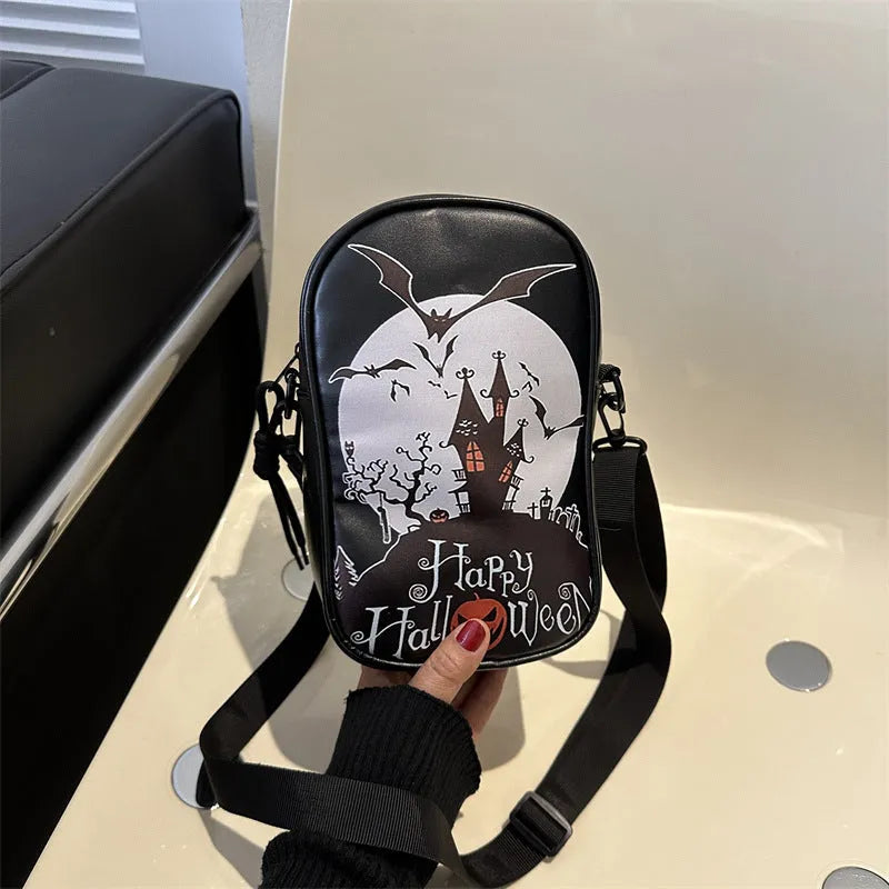 Black mini crossbody bag with Halloween graffiti print of cartoon pumpkins and bats.