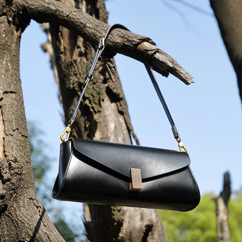 Women's cowhide leather cross-body bag in clamshell design with internal organisers