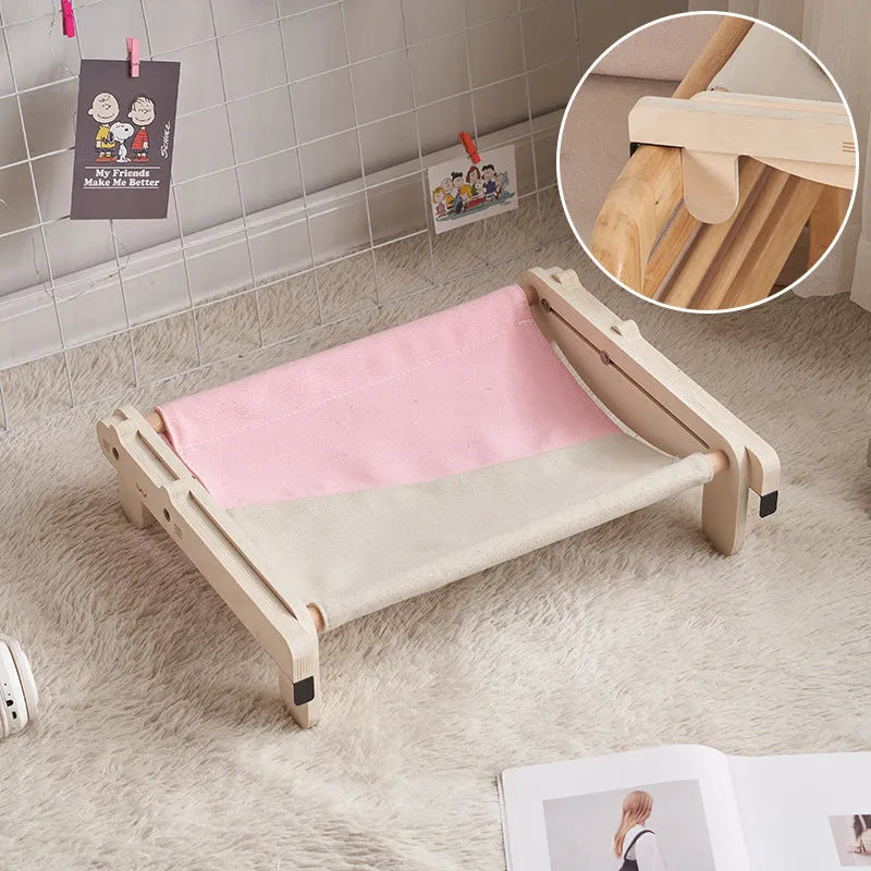 Solid wood cat bed with a removable patterned cover on a wooden floor