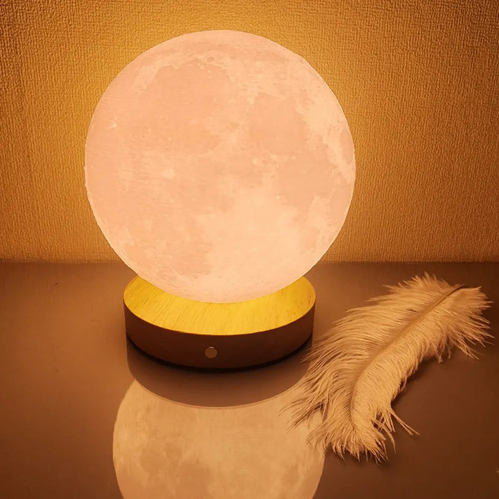 Rotating sleeping moon night lamp on wooden base showing three-colour light options.