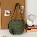 Corduroy crossbody shoulder bag in black with ribbon pendant, horizontal square shape