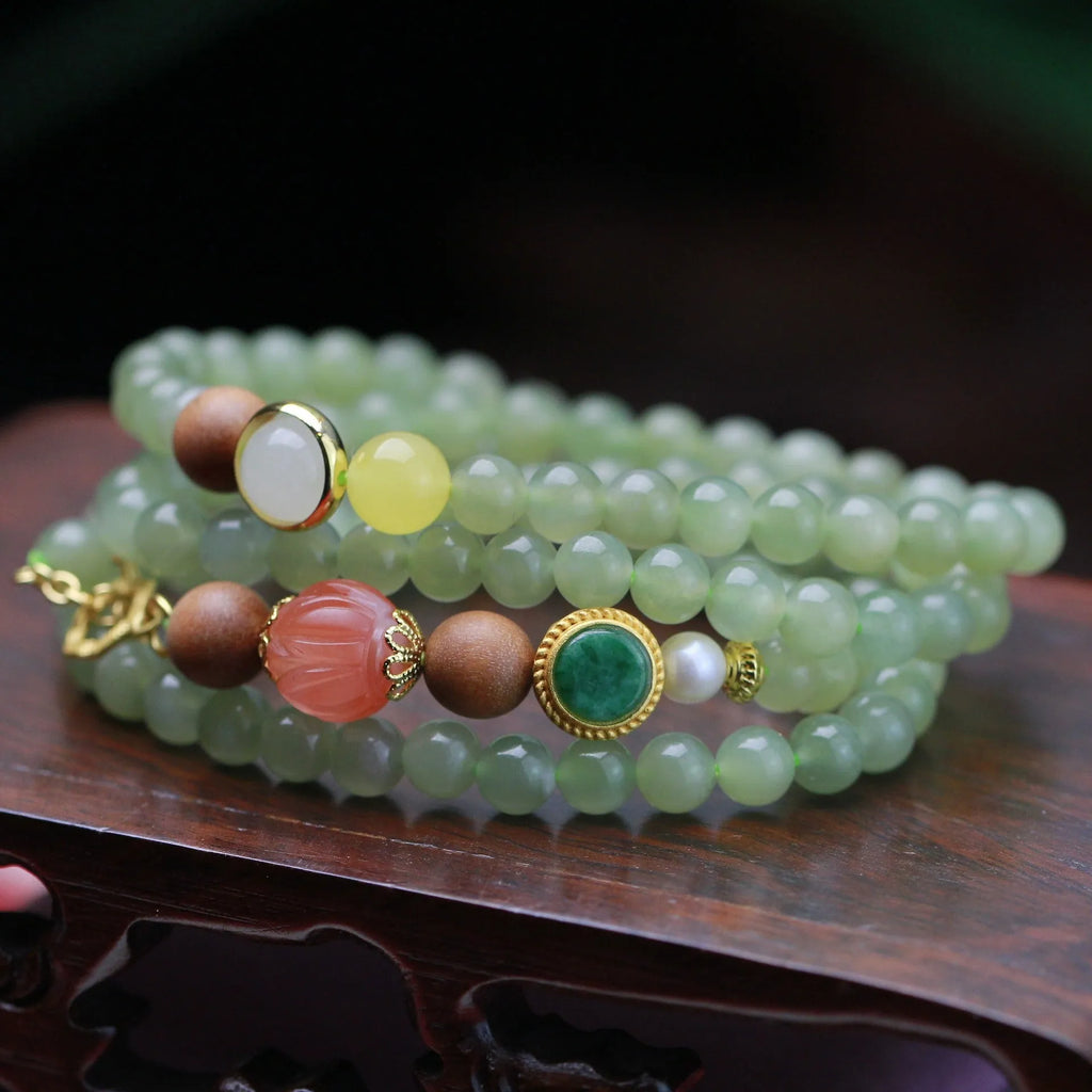 Hetian jade and sandalwood necklace with lotus beads and animal pendant, plus matching bracelet.