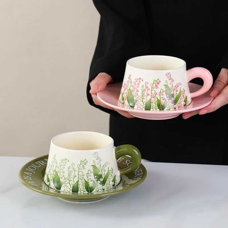 Ceramic coffee cup and saucer set with two cups, two saucers, and two stirring spoons