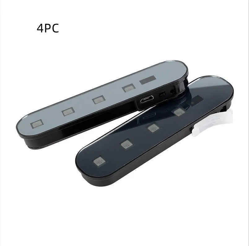 Car door induction lamp with magnetic base showing colourful T-style light projection on ground