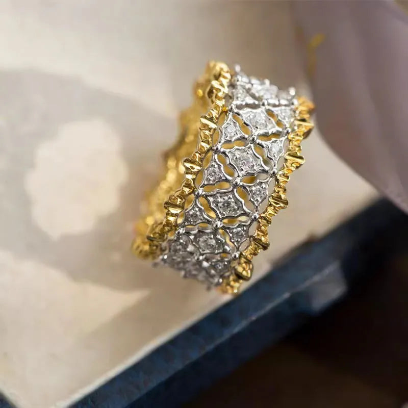 Geometric copper zircon ring with a two-tone gold and silver electroplated finish and a round stone.