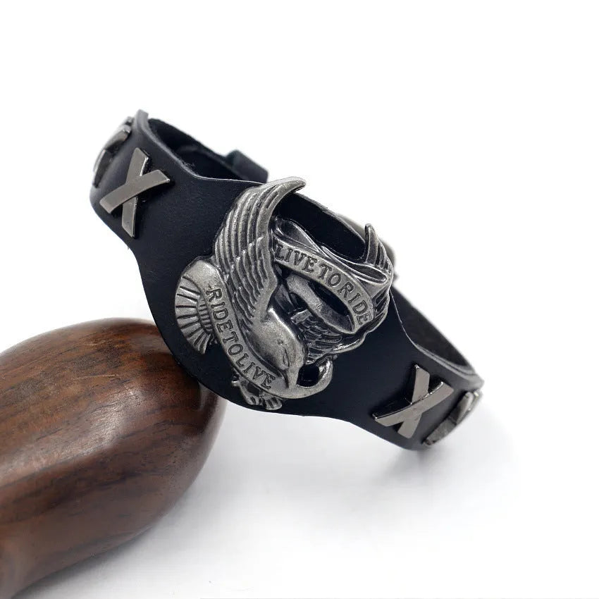 Black leather eagle geometric pattern bracelet with watch-button clasp on wrist