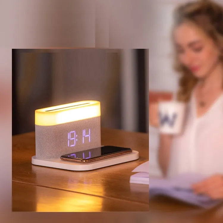 Black or white table lamp with integrated wireless phone charger, LED clock display, and nightlight functions