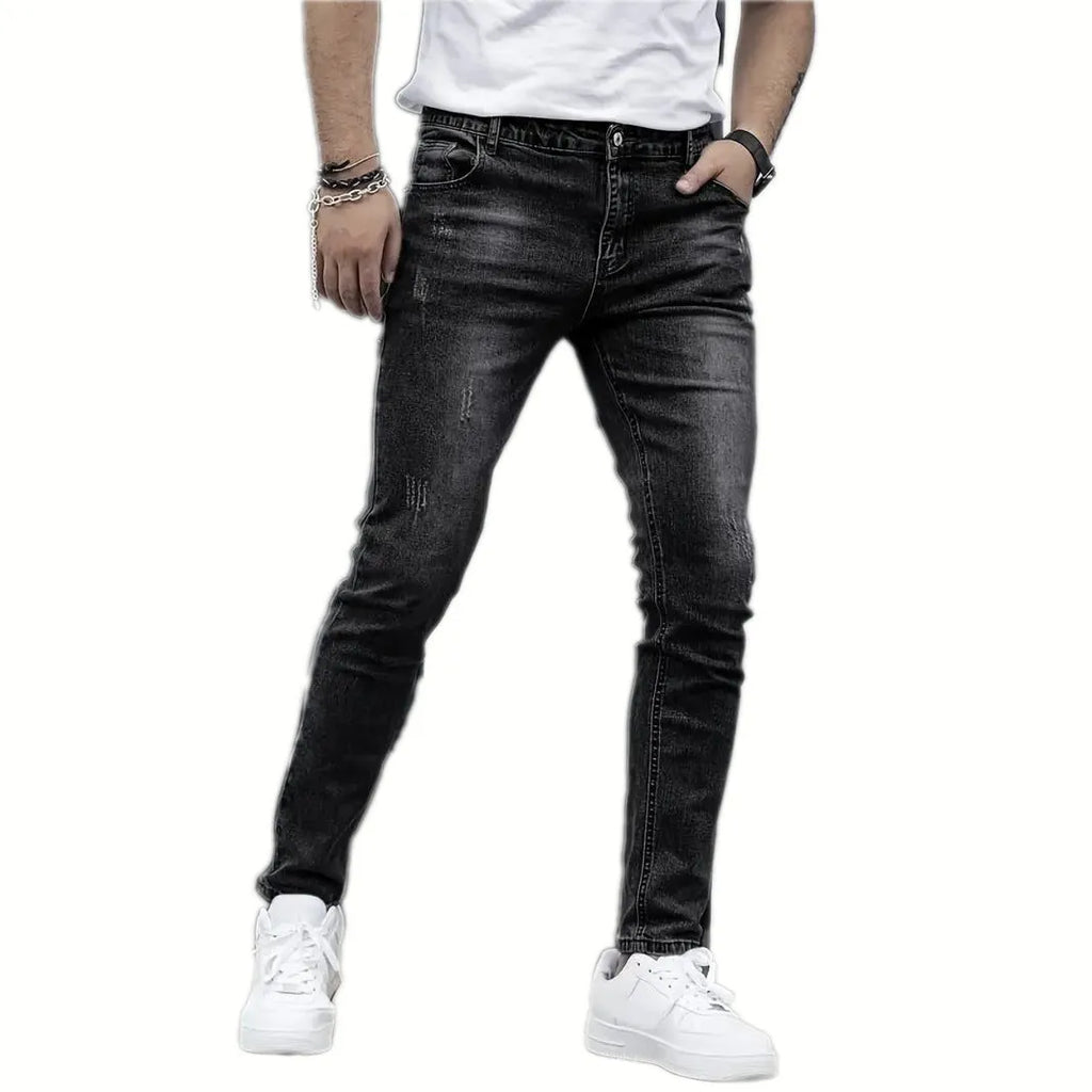 Men's black stretch skinny jeans showing high elasticity cotton-spandex fabric with zipper fly and straight leg cut
