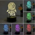 Black-based acrylic dream catcher night light with colourful LEDs on a table.
