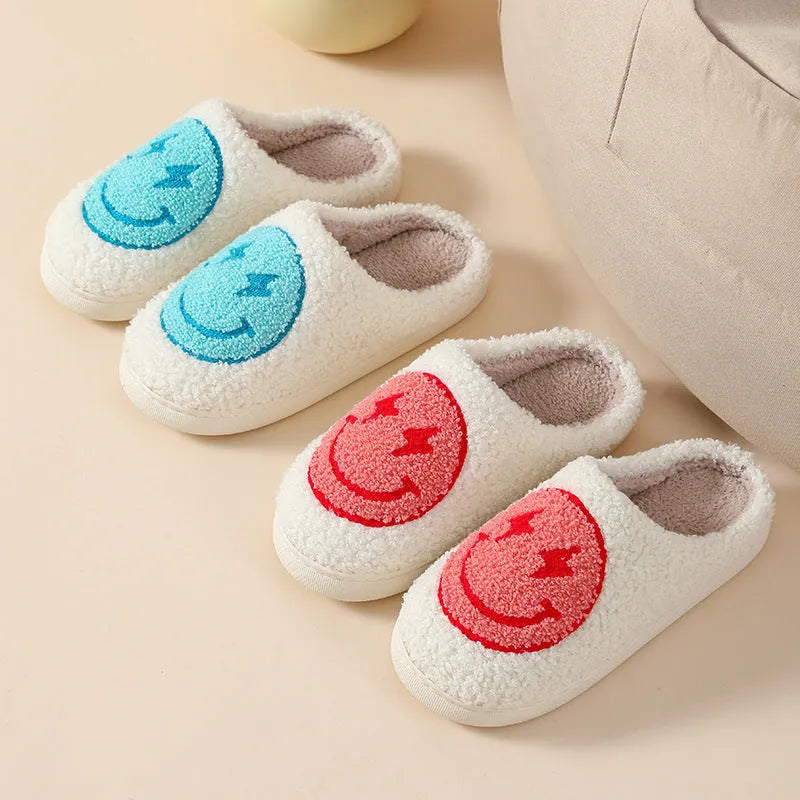 Women's plush slippers with cartoon love design, showing round toe and non-slip PVC sole.