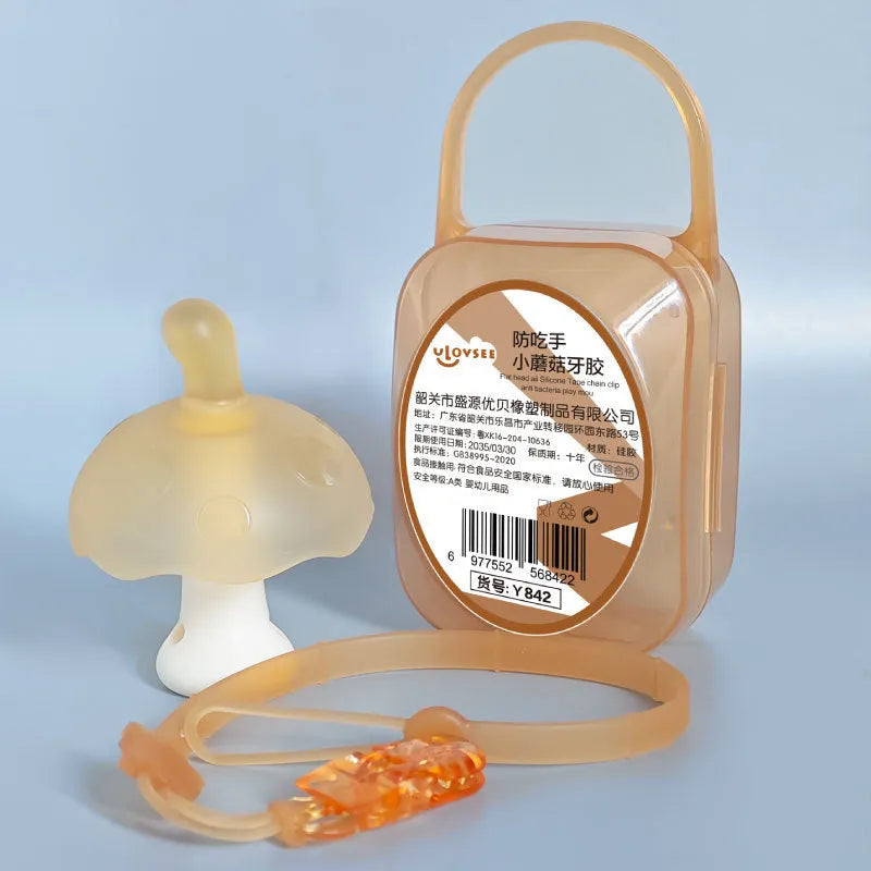 Small pink mushroom-shaped silicone gum replica in a transparent box with a chain.