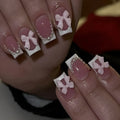 Pack of short white French manicure nail stickers with bow, tulip, and starry sky patterns.
