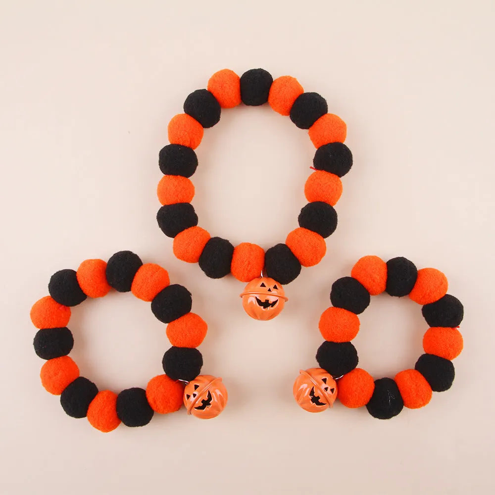 Orange pumpkin-patterned adjustable cat collar for Halloween worn by a cat.