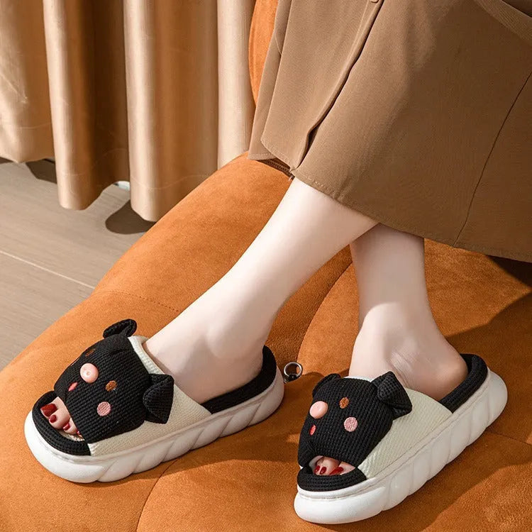 Pair of open-toe linen flip-flop slippers for couples on a plain background, showing colours and strap detail.