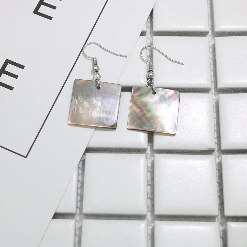 Geometric shell earrings in square panther or rectangular shell designs with natural finish
