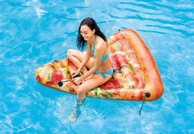 Large green and beige pizza-themed inflatable surfboard lounger floating on water