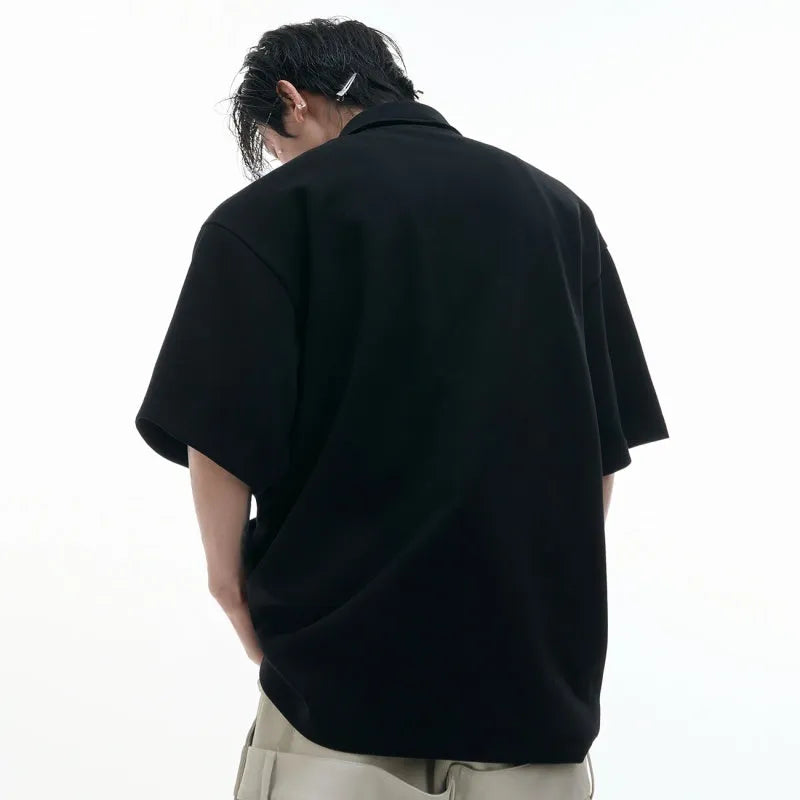 Men's loose fit deconstructed collar polo shirt with geometric pattern in black, grey, and white.