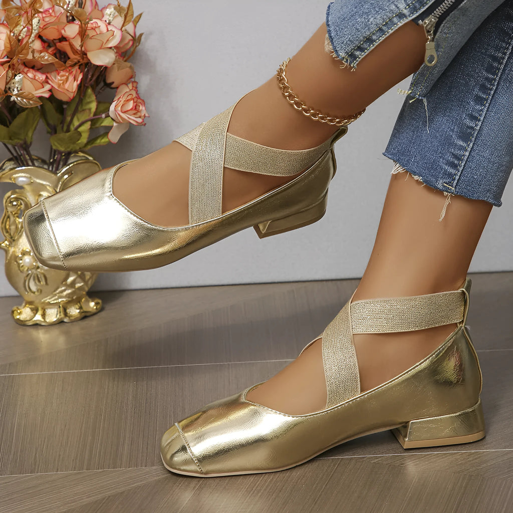 Gold slip-on evening pumps with a flared skirt collar, square toe and low rubber sole.
