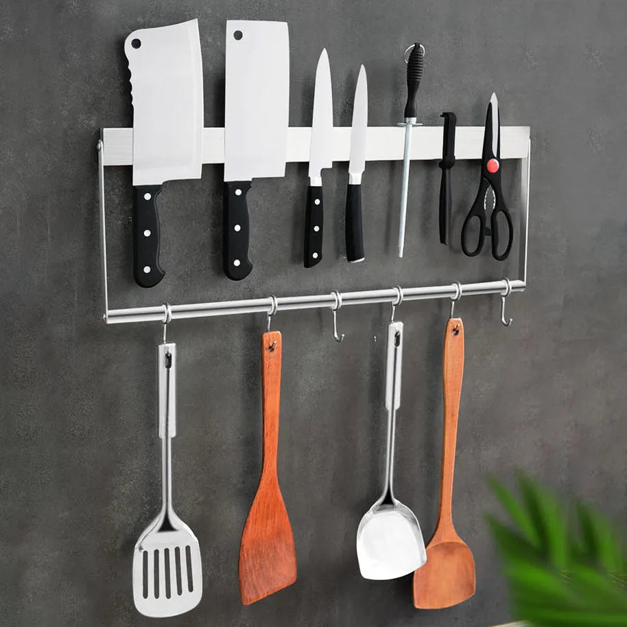 Stainless steel wall-mounted kitchen knife storage rack on white wall