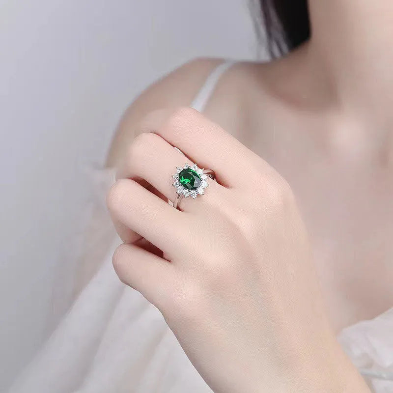 Women's floral copper ring with a blue moissanite centre stone on a model's finger.