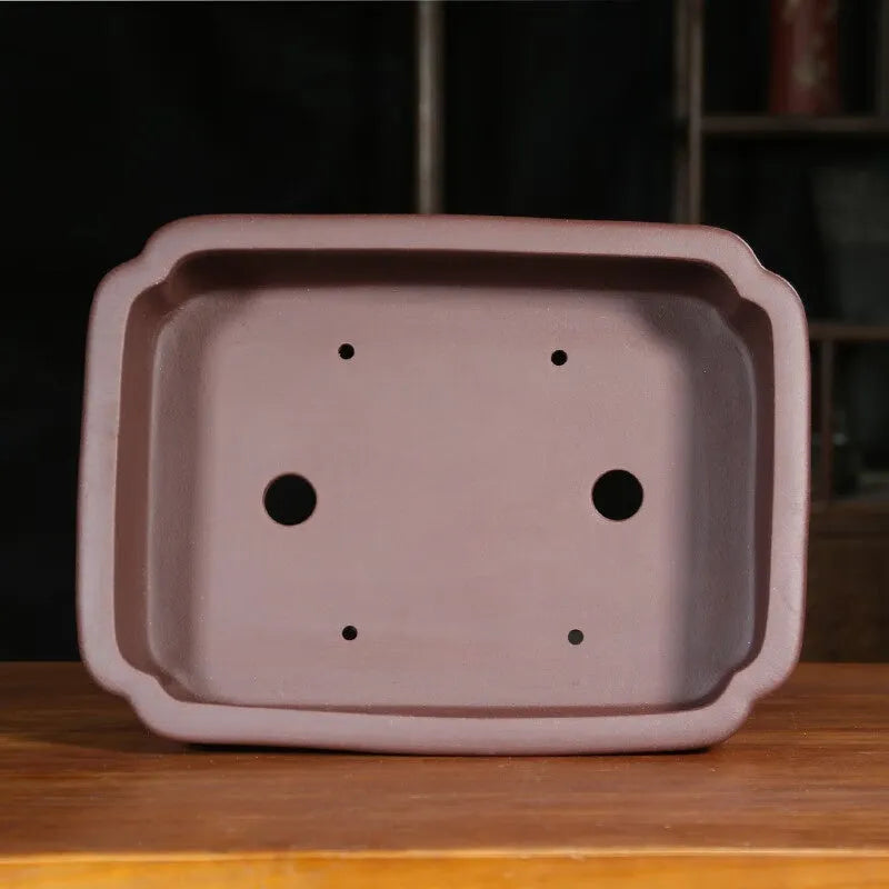 Antique rectangular purple sand clay bonsai pot on a floor, shown in two size options.