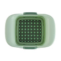 Green manual vegetable chopper with stainless steel blades for slicing potatoes and dicing onions.