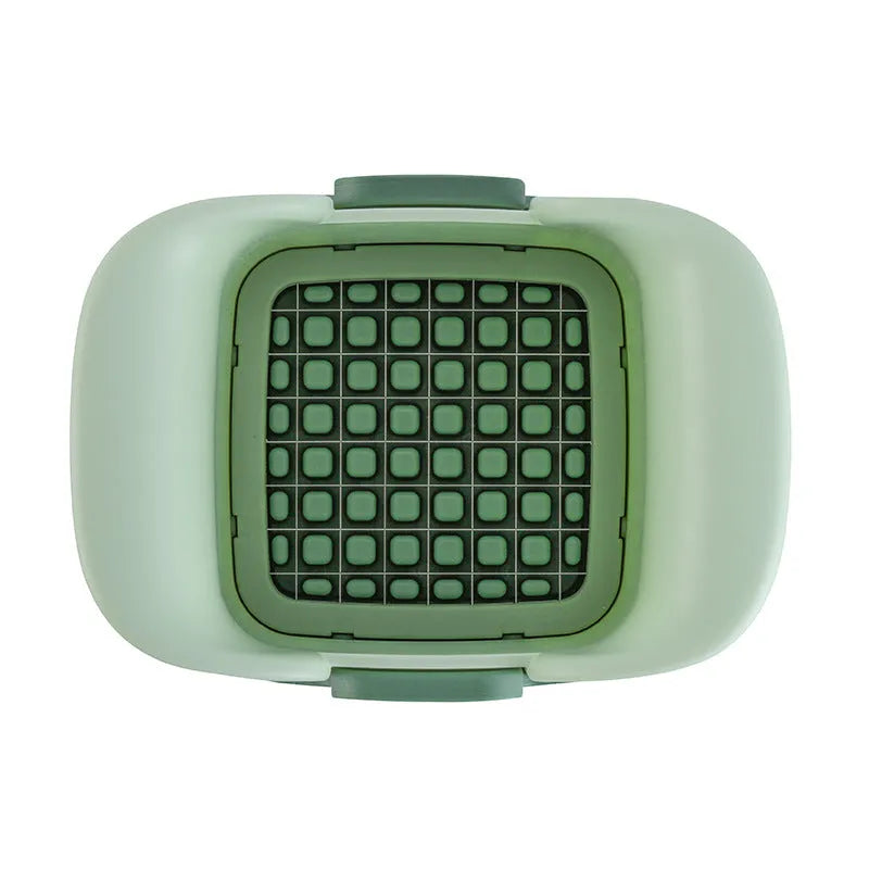 Green manual vegetable chopper with stainless steel blades for slicing potatoes and dicing onions.