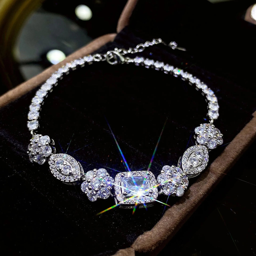 Women's geometric silver-plated bracelet with inlaid zircon stones on a wrist.
