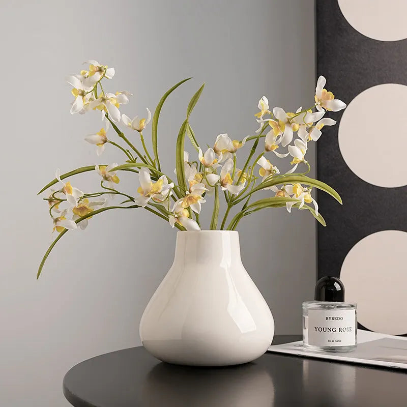 Ceramic round belly vase with coloured glaze finish and two orchid flowers in modern simplicity design
