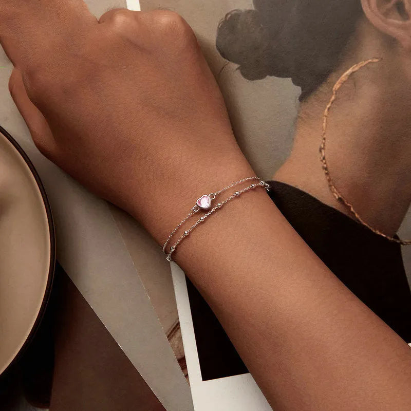 Sweet style sterling silver bracelet with small heart pendant on an adjustable chain.