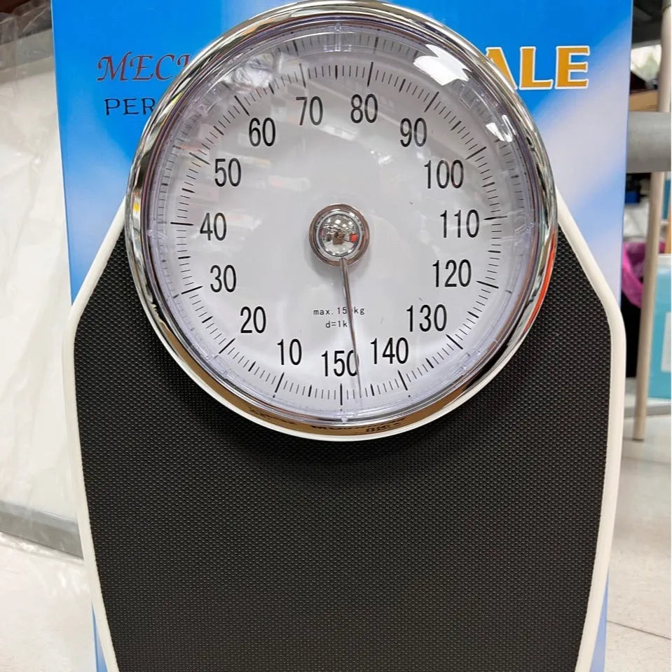 Black mechanical weight scale with large dial measuring 47x35x11cm