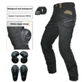 Man wearing green waterproof motorcycle trousers with belt and protective gear for cycling.