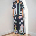 Black women's casual set with cartoon print, featuring a sleeve cardigan and trousers