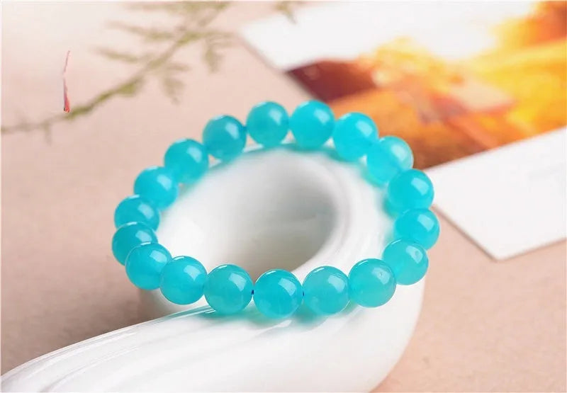 Natural blue-green Amazonite scattered bead bracelet on a wrist, showing polished stone beads in an original design.