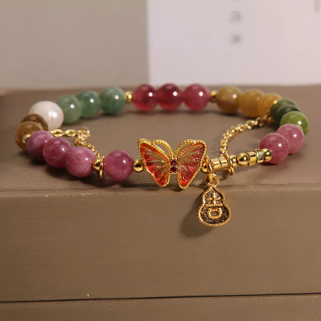 Women's tourmaline butterfly gourd bracelet with agate, showing jade coloured carved centrepiece.